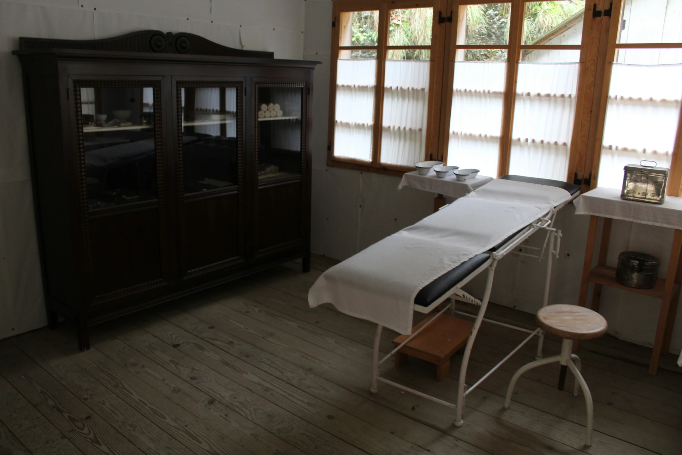 an ironing board in a small room next to a window