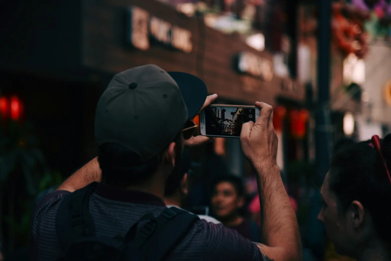 two people taking a po with their cell phones