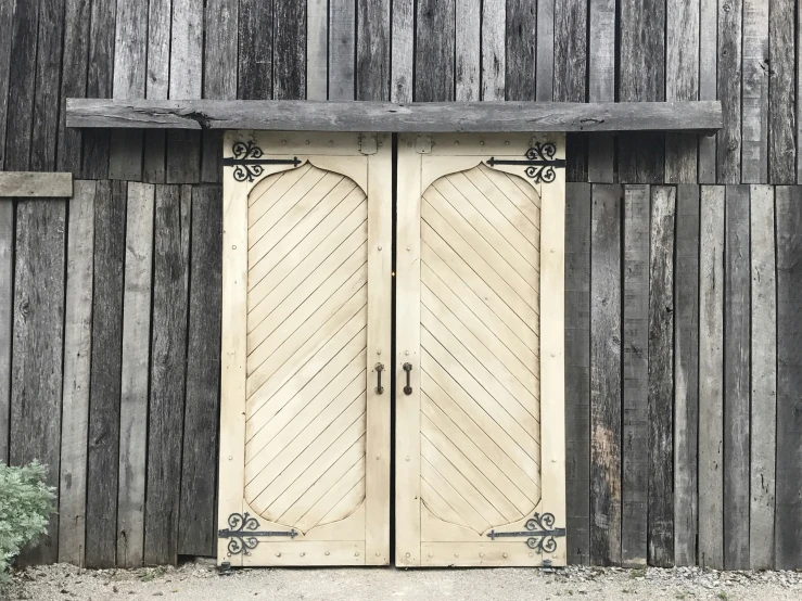 large door with ornate wooden panels outside on wall