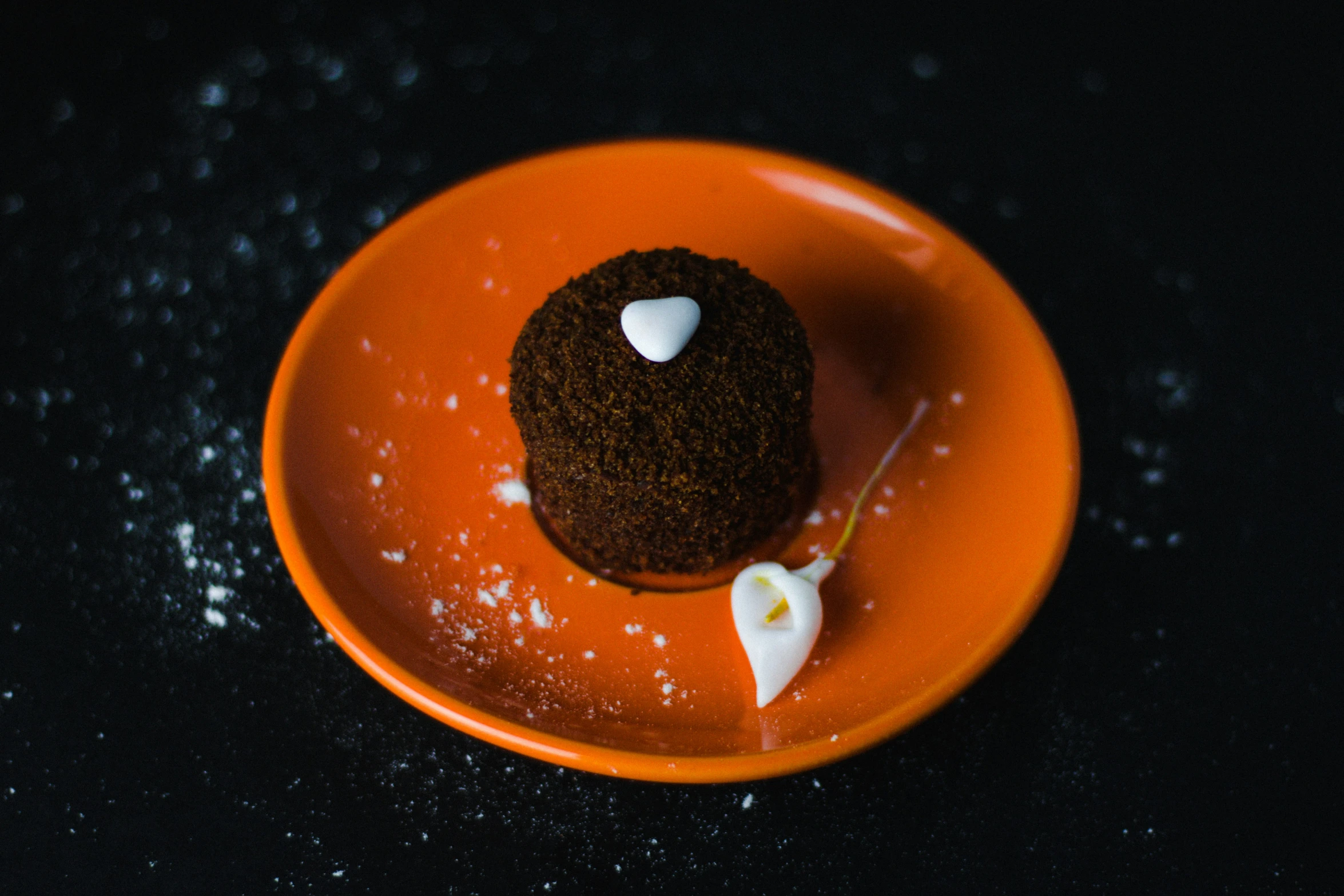 an orange plate holding a tasty looking pastry