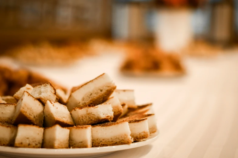 plate of food sitting on a table, including small pieces of bread