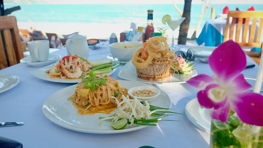 two plates with food and some beverage sitting on the table