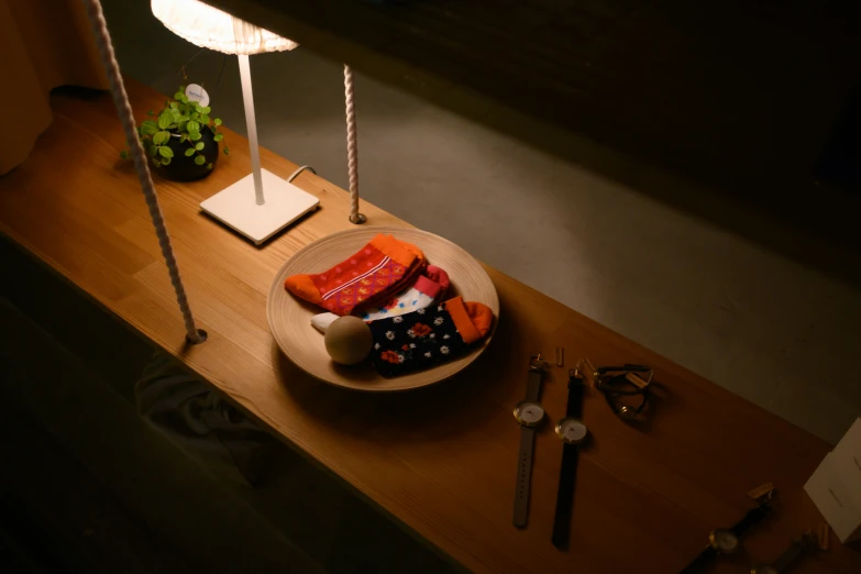 a wooden table with a plate of candies and candles on it