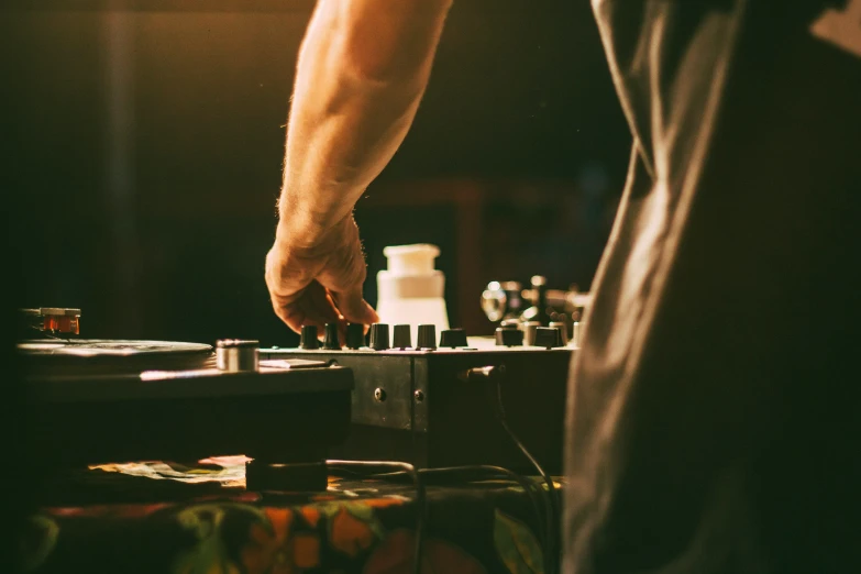 a man standing next to a record player