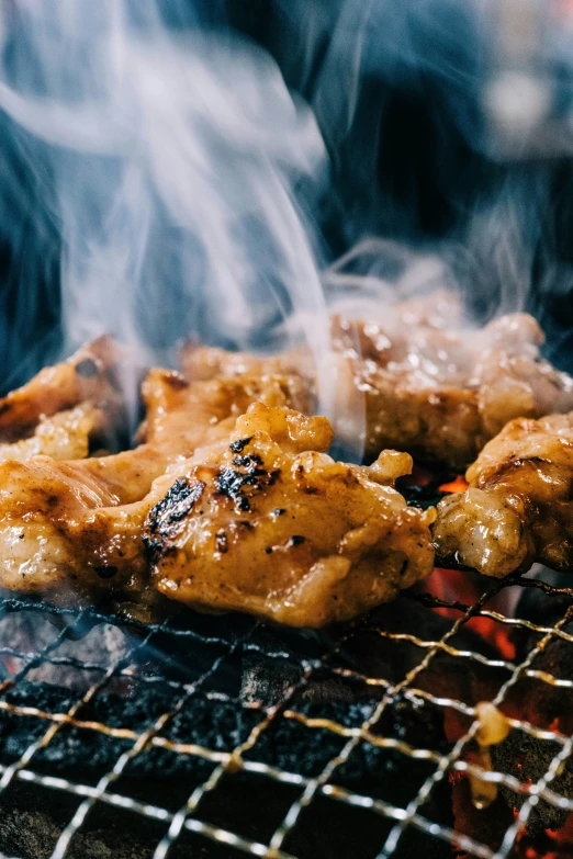 a bbq with chicken cooking on the grill