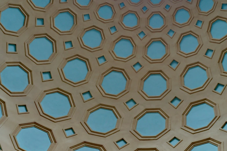 there is a circular glass structure with hexagonal holes