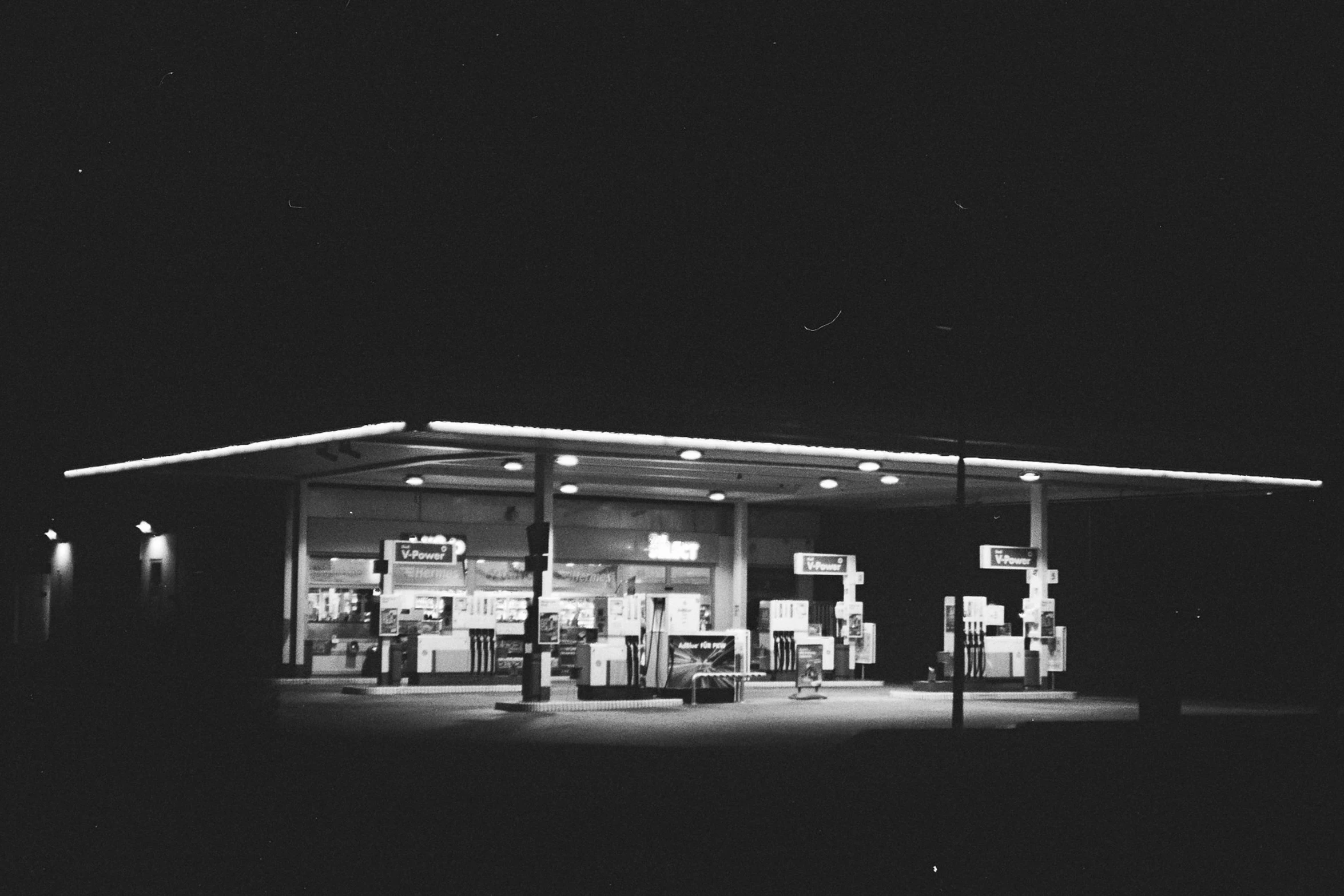 black and white image of a gas station