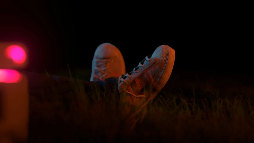 a pair of shoes sitting on a ground in the dark