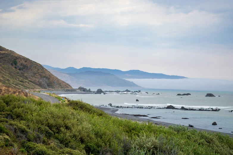 view along a coastline of beach with boat in water