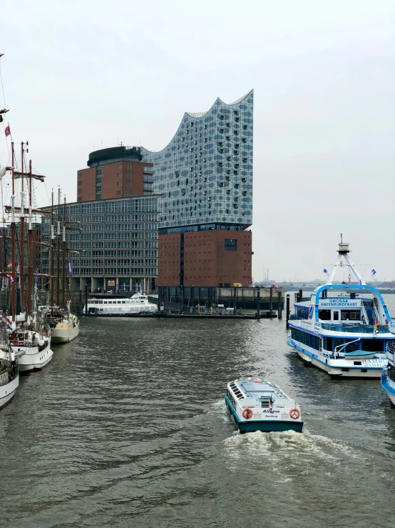 ships and ferries at a boat dock in front of a large building