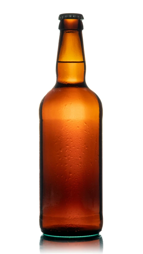 a close up view of a brown bottle on a white surface