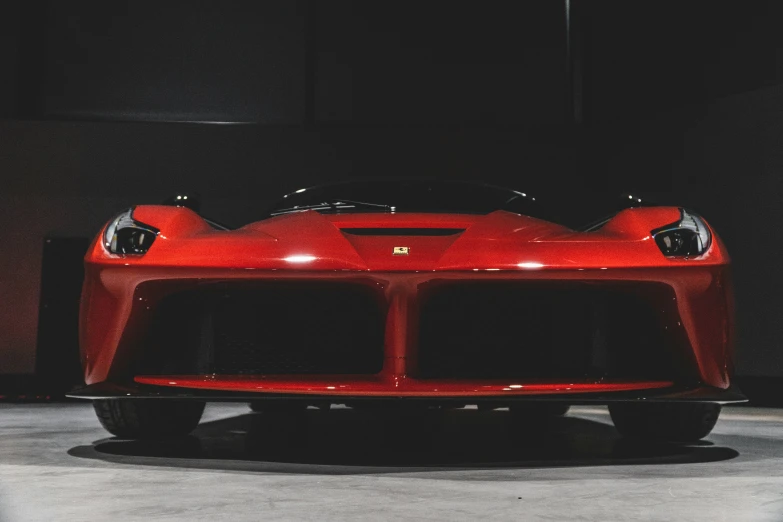 a red sports car parked in the dark