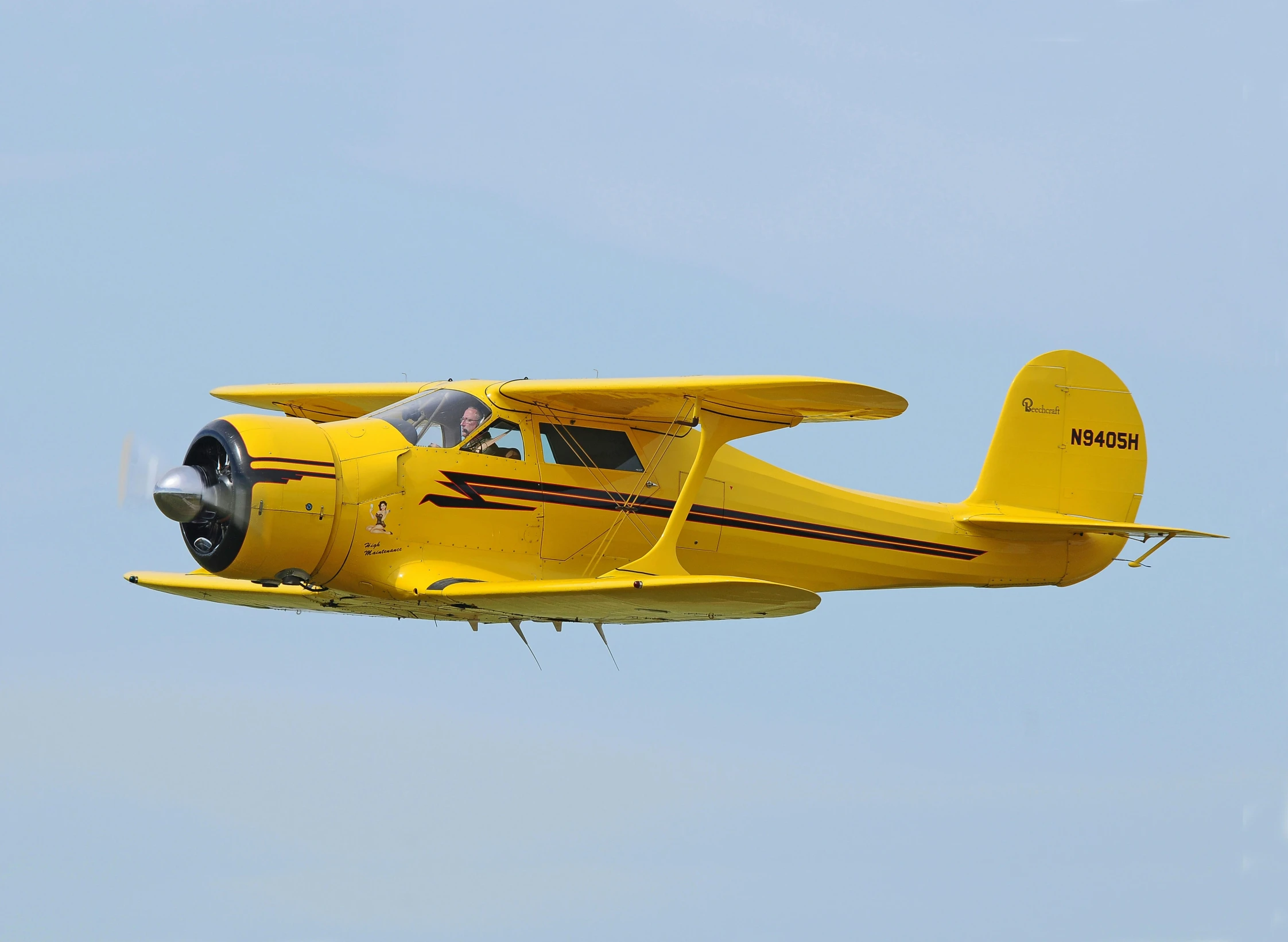 an airplane flying through the air in a blue sky