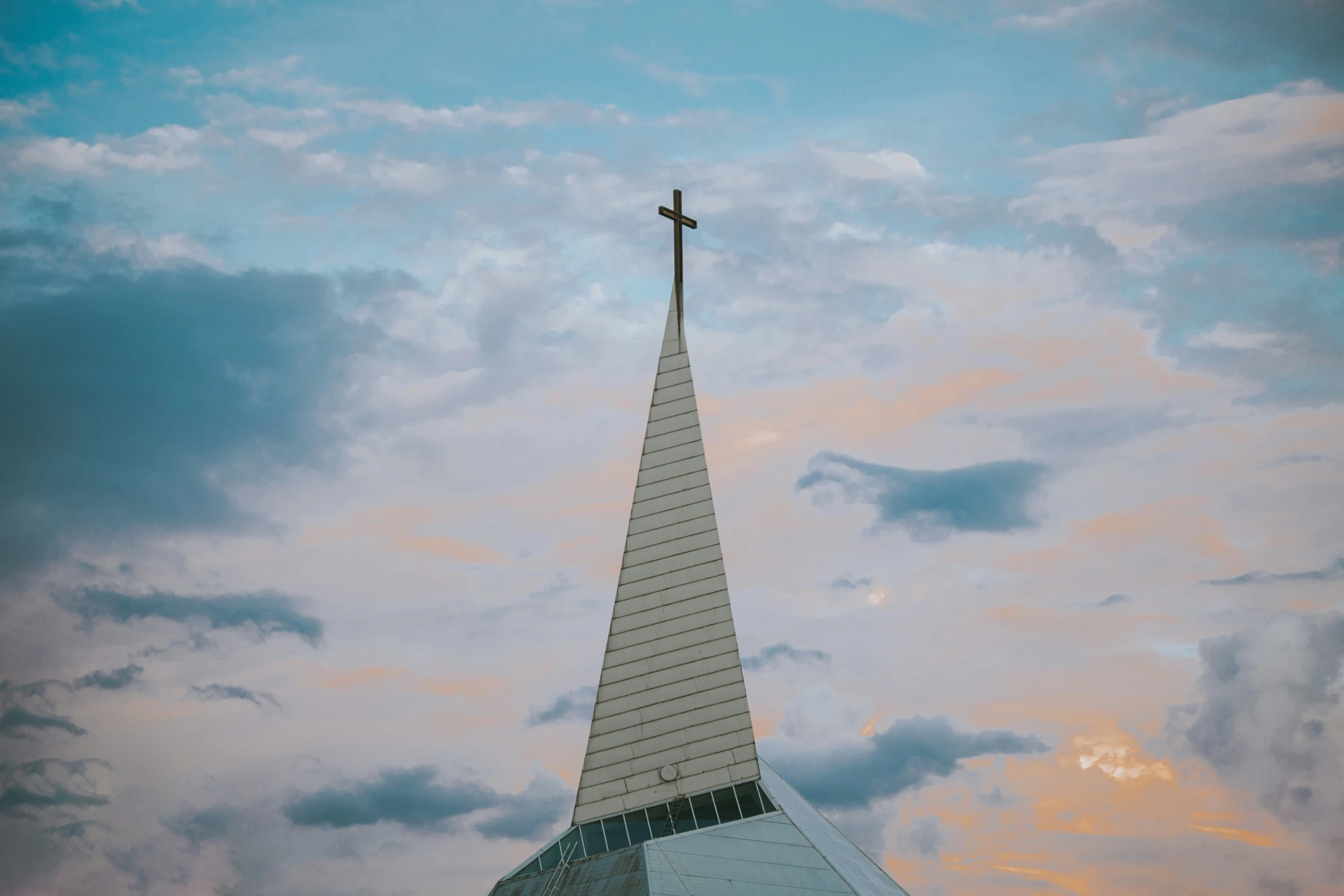 a tall church steeple on a cloudy day