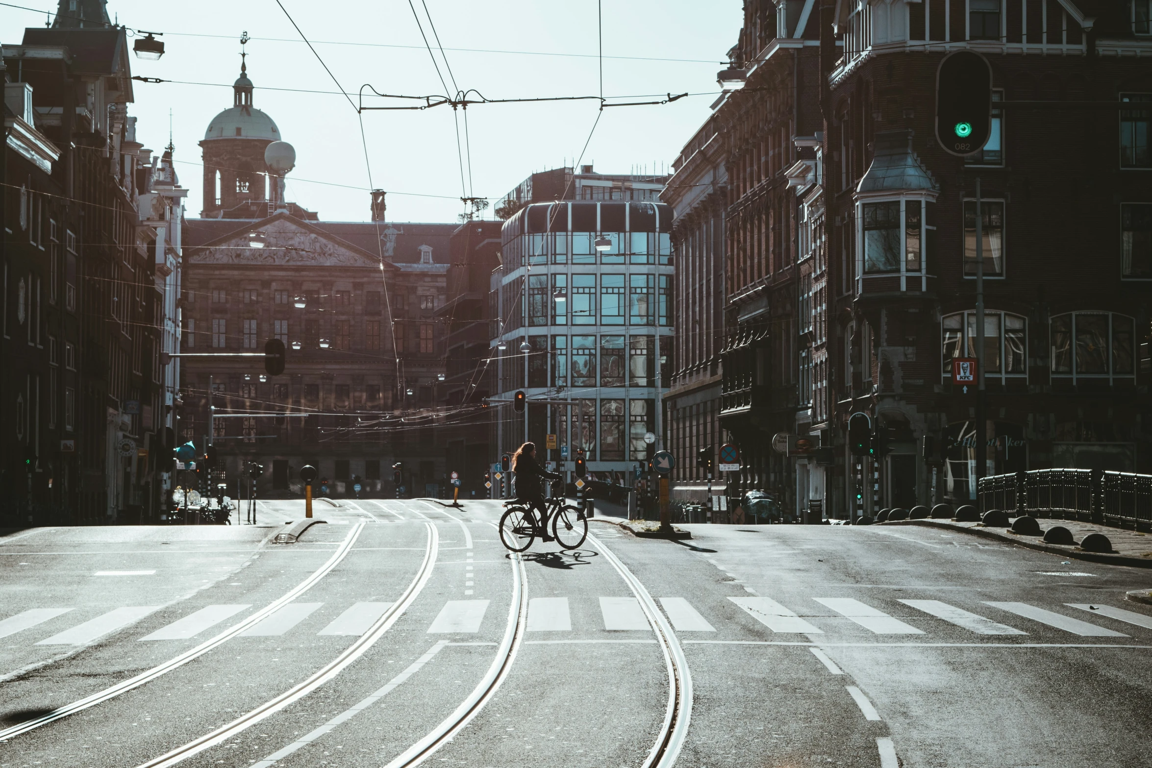 the view from the inside of a city street, looking at a train track