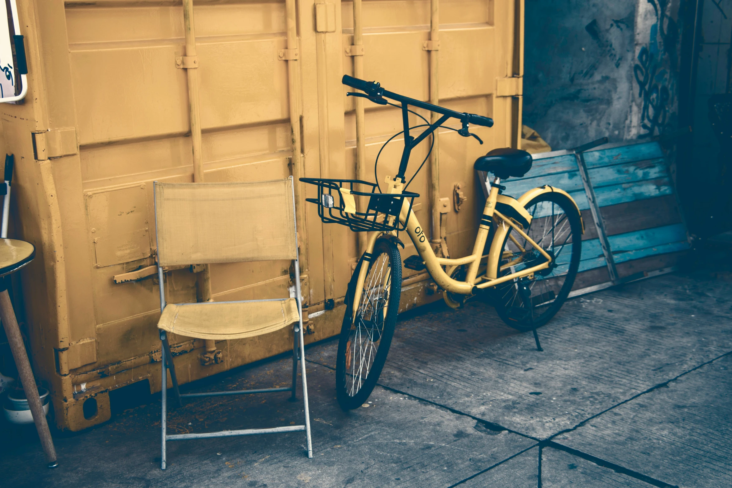 two folding chairs next to an orange bicycle