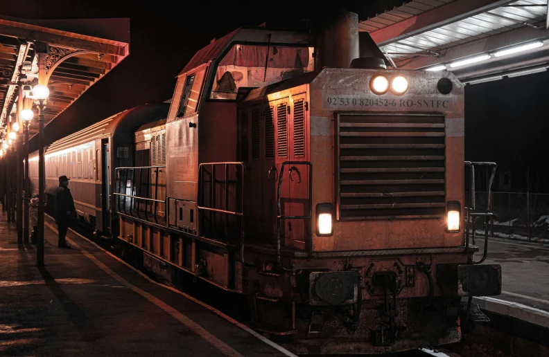 a train traveling down train tracks near a platform