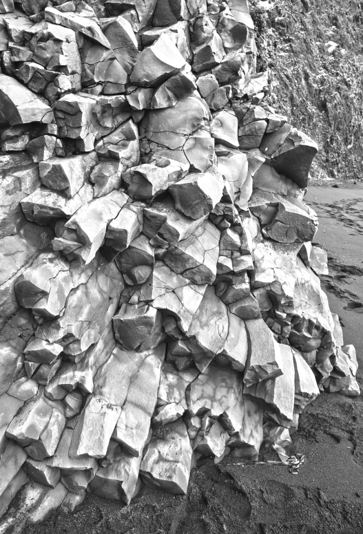 a large pile of rocks next to a cliff