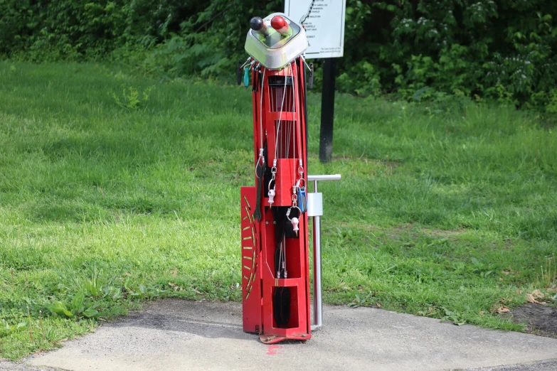 an old fashioned red telephone has been hooked up to a post