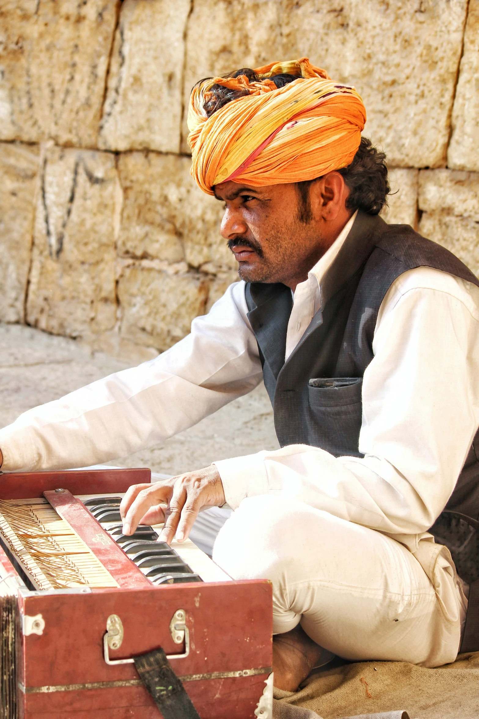 a man playing a musical instrument on the street