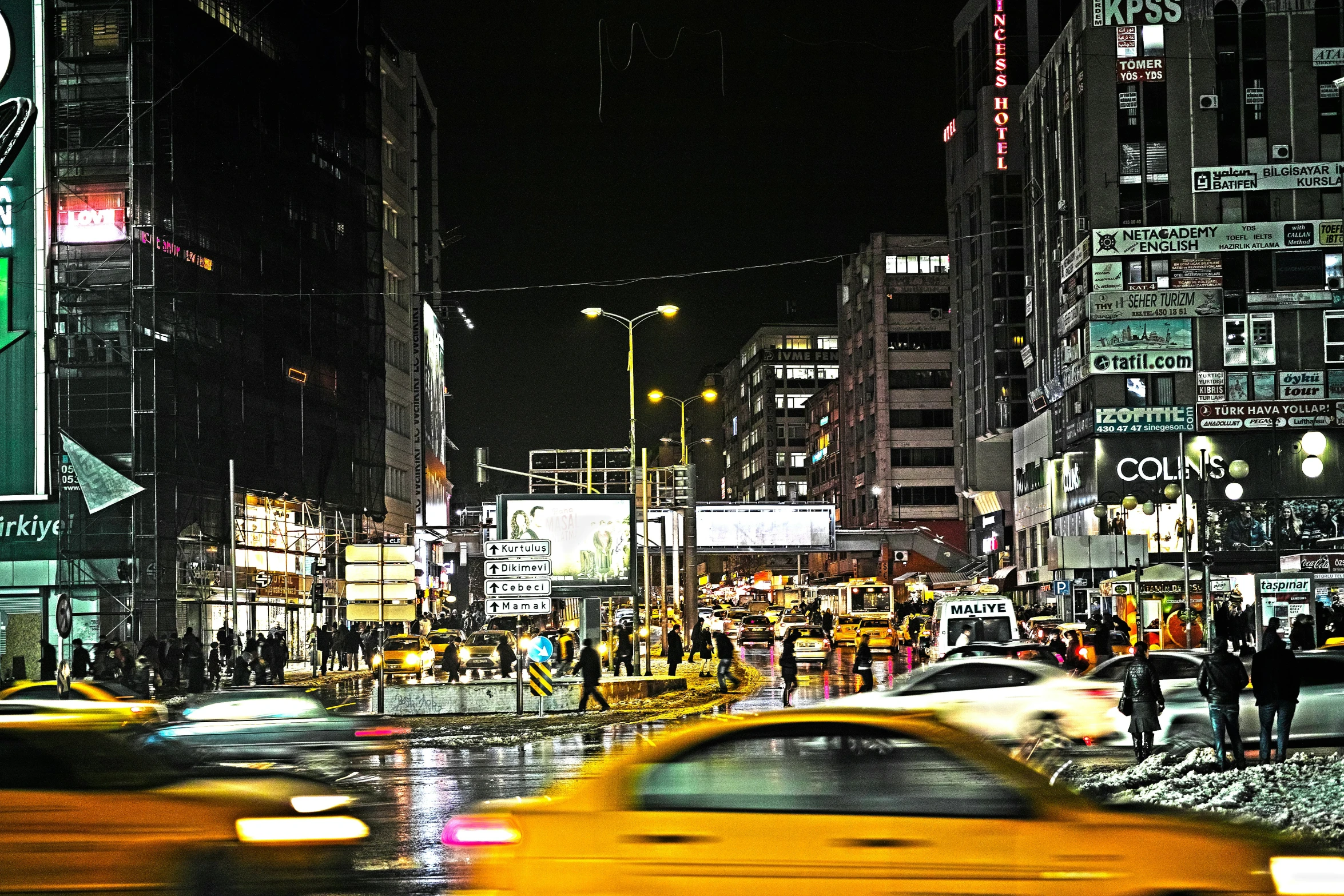 traffic and pedestrians at night with traffic lights