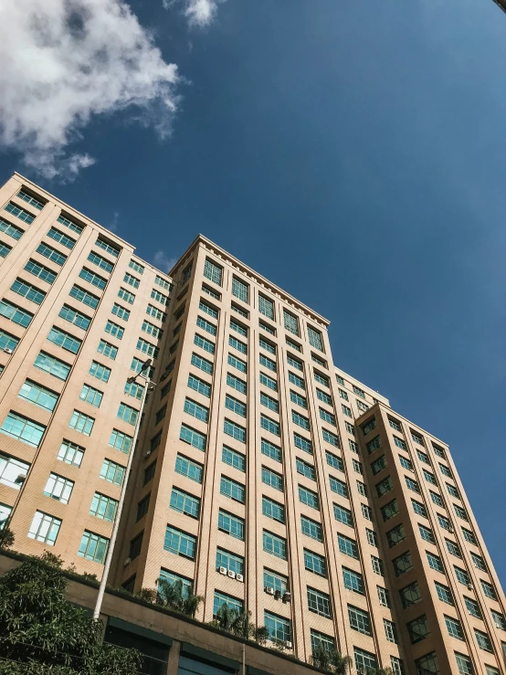 a tall brown building sitting under a blue sky