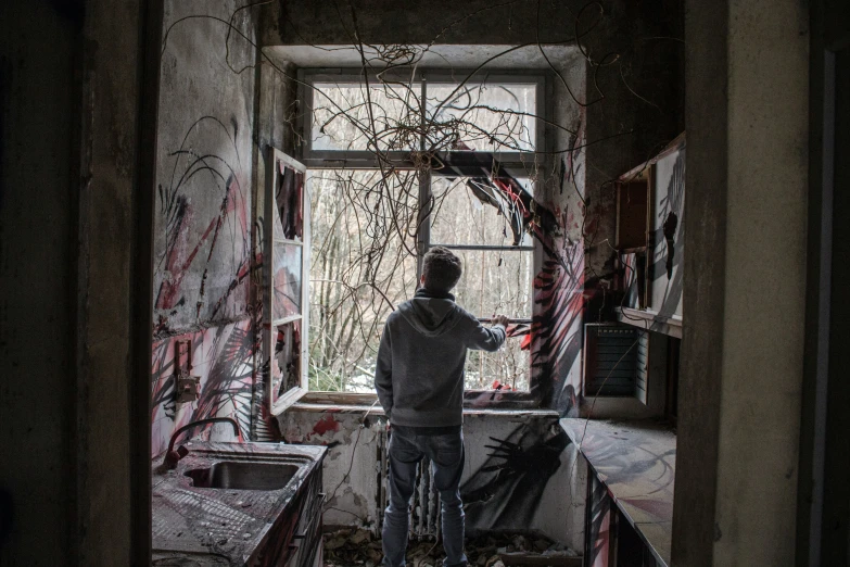 a person on a bike looking out an old window