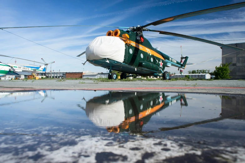 a helicopter sits in front of the camera on the concrete