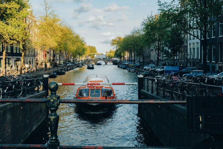 a boat driving down a river surrounded by bikes