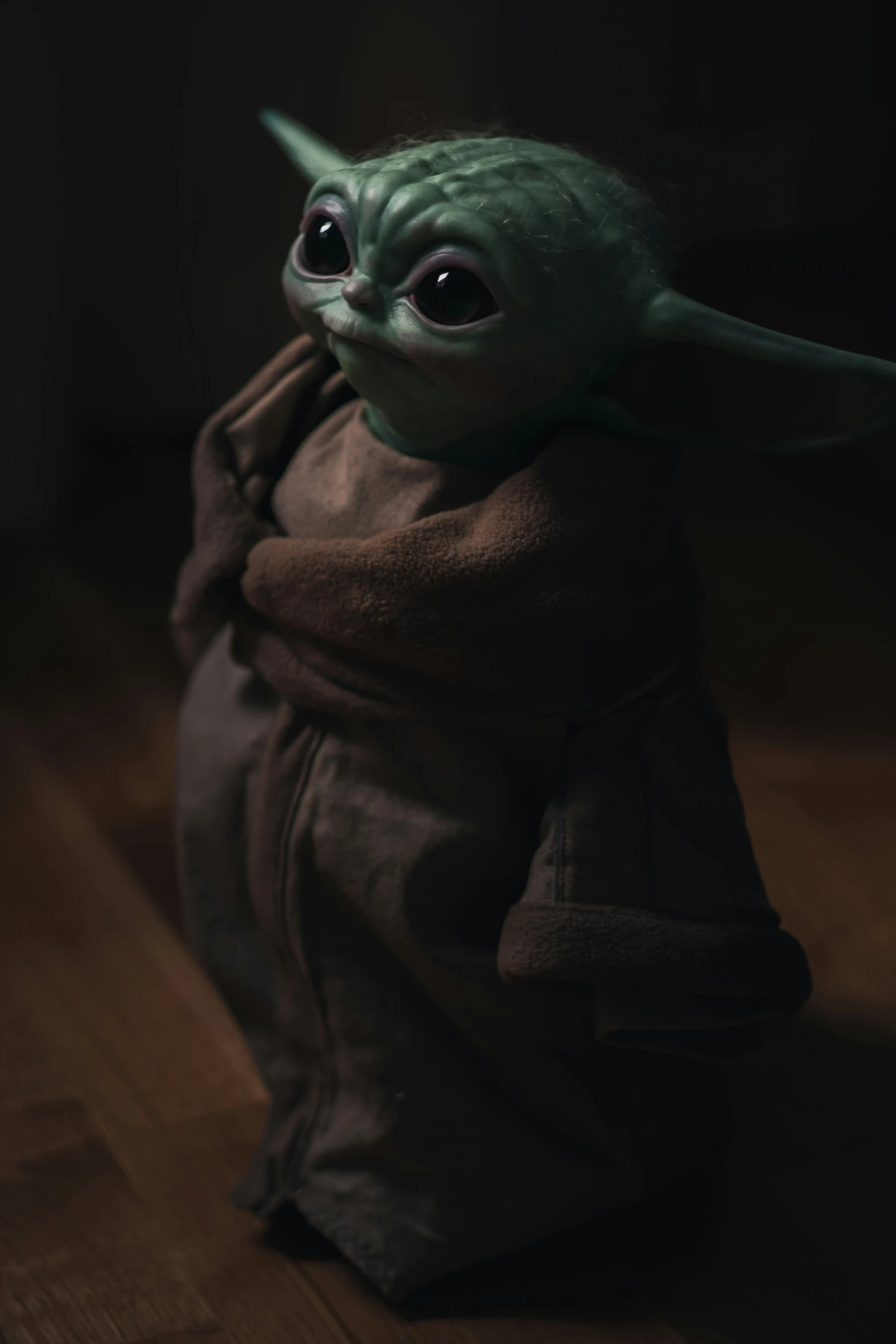 the baby yoda doll is in the dark
