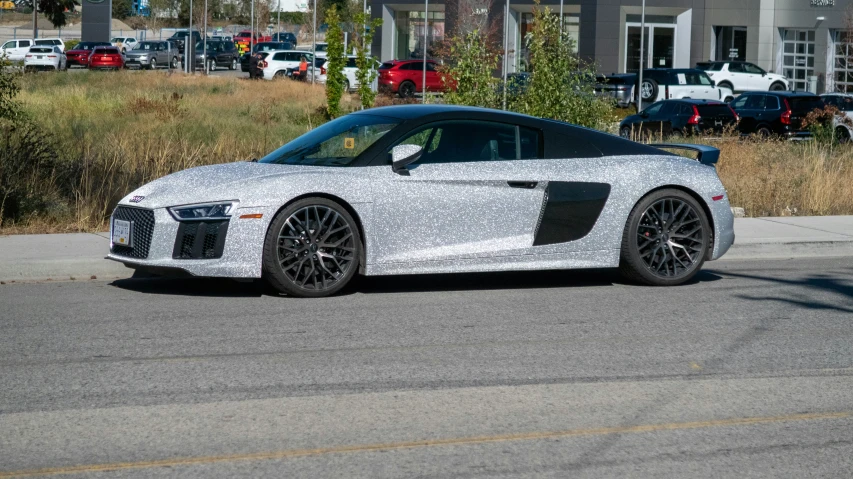 the grey audi car is parked at the curb