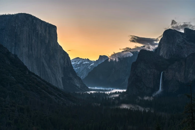 the sun sets over the mountain, and a beautiful landscape