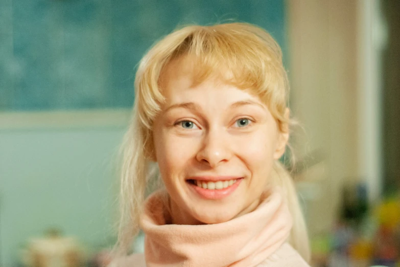 a woman in pink coat smiling at camera