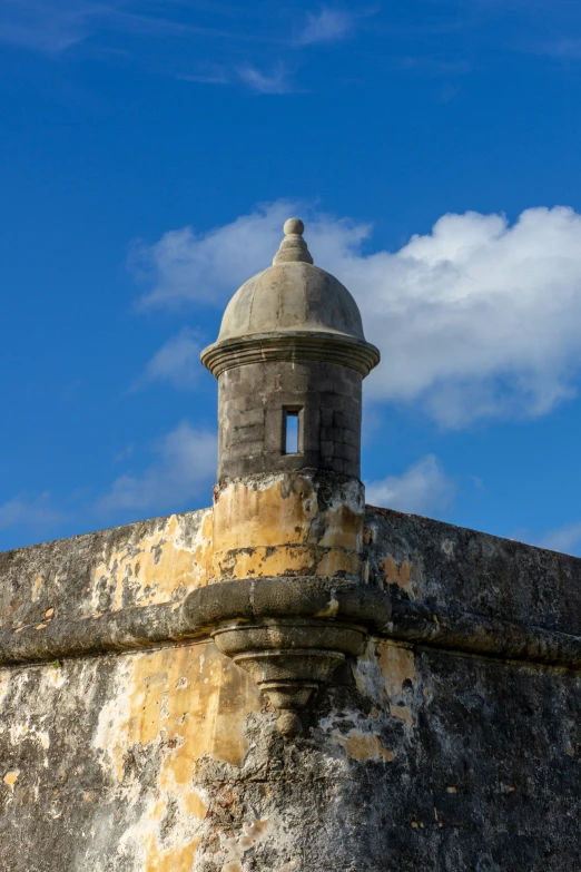 a view of an ancient structure with a bell on top