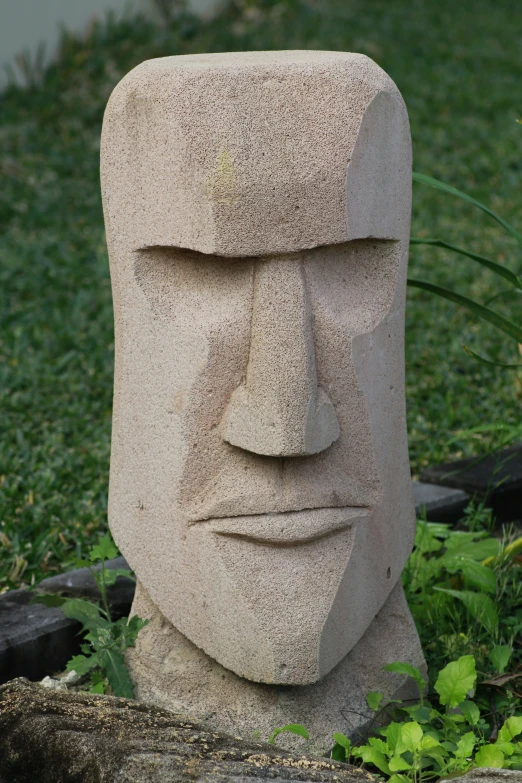 a cement statue with eyes drawn on it