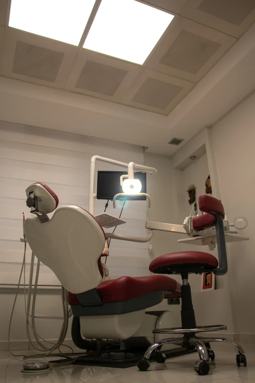 a chair in the foreground is a light and the ceiling has two white lights on it