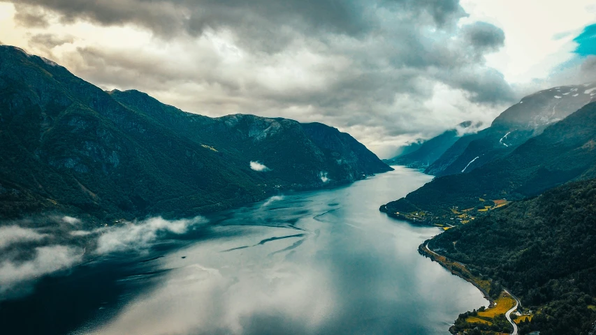 an aerial view looking down on a lake and mountains