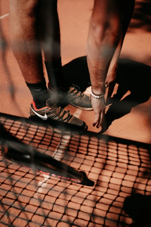 a person on a skate board with his shoes on the ground