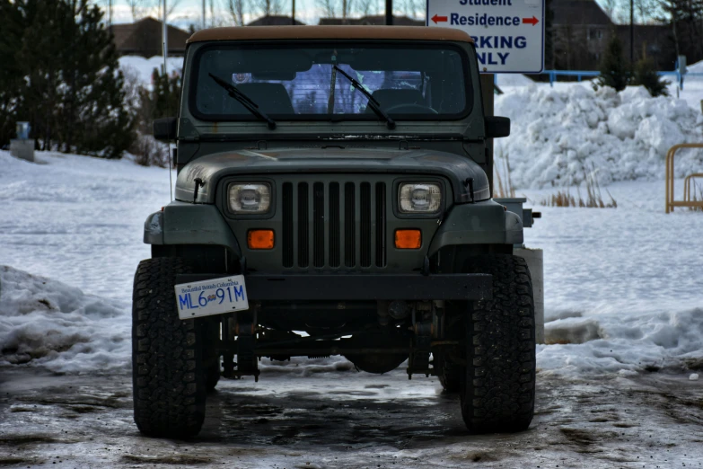 a jeep driving in the snow with a car warning drivers to get off