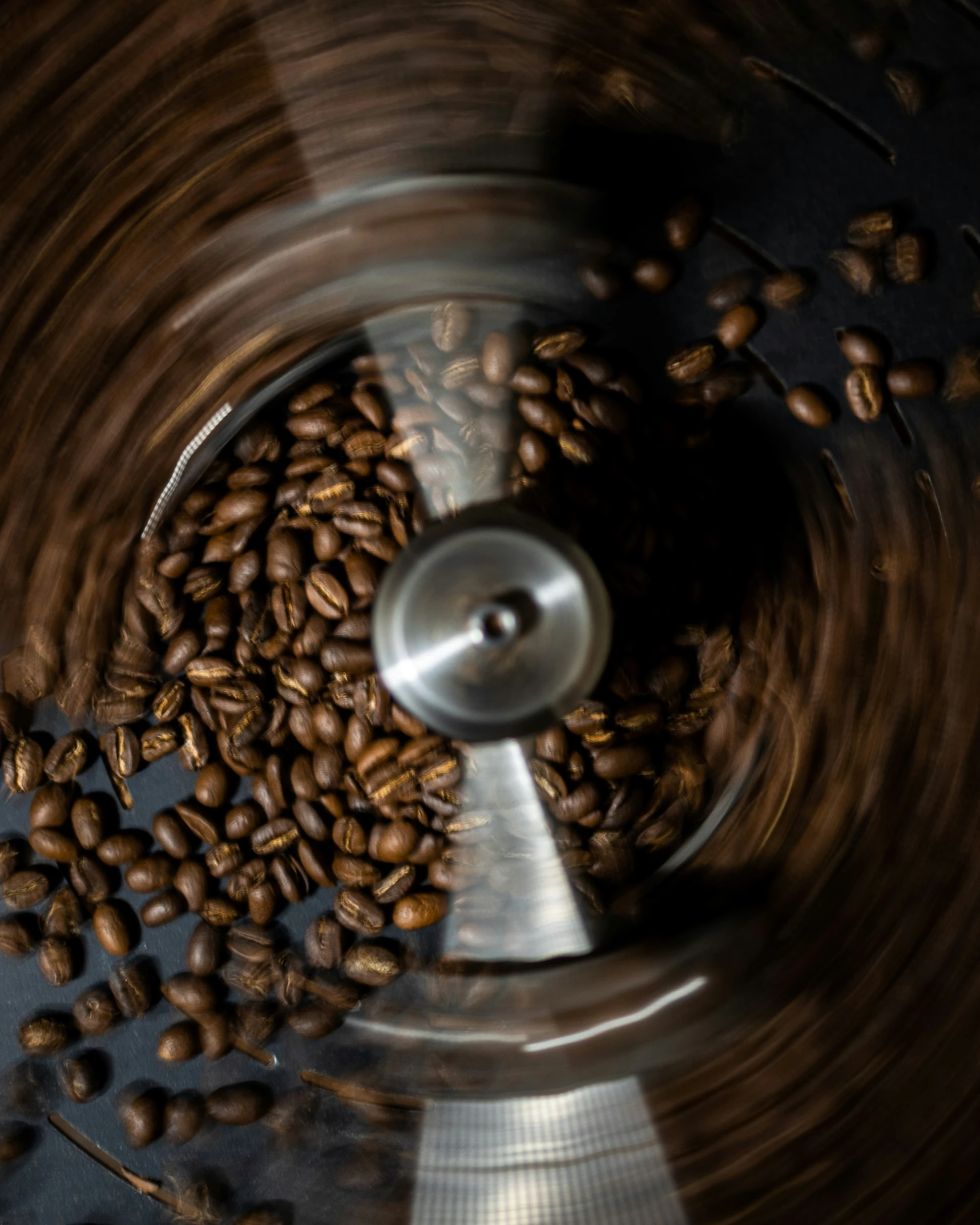 a coffee grinder is filled with brown coffee beans