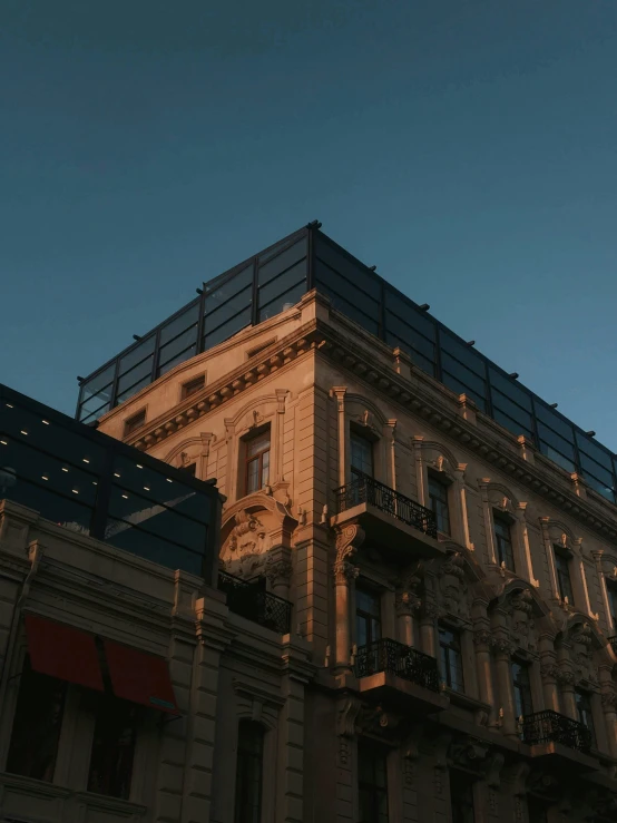 a tall brown building with a black top