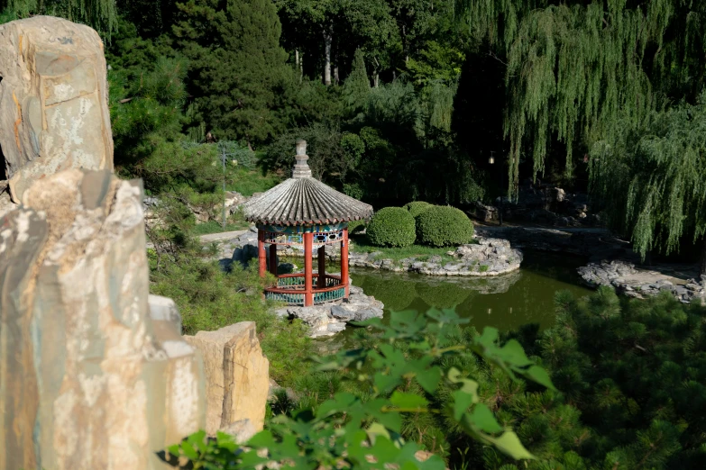 an oriental park with rock gardens in the foreground