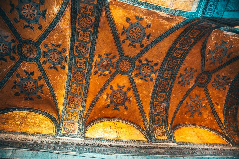 a ceiling is made up with many ornate designs