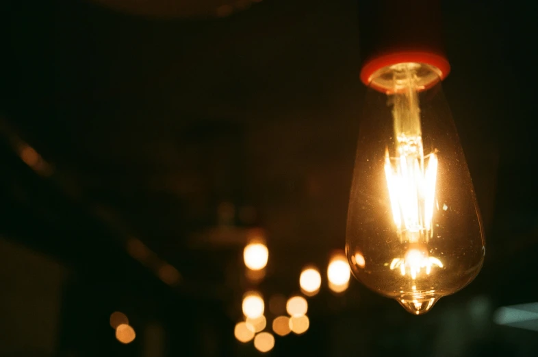 light bulbs shine brightly as they are lit by candles