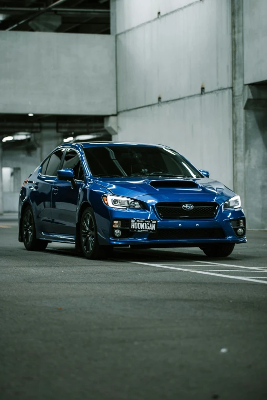 blue car in a parking lot, with no one around