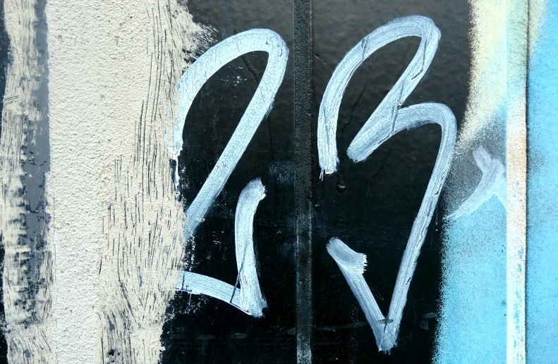 the black and white image of numbers is near a wall