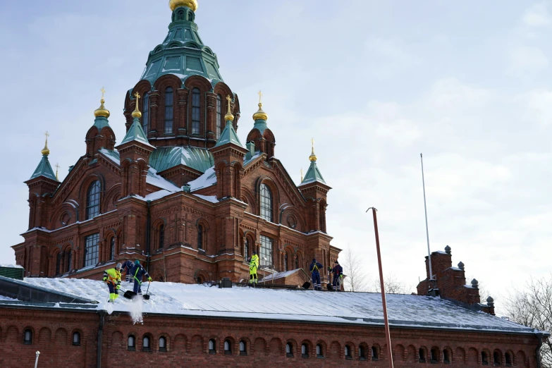 the tall building is on top of snowy roof