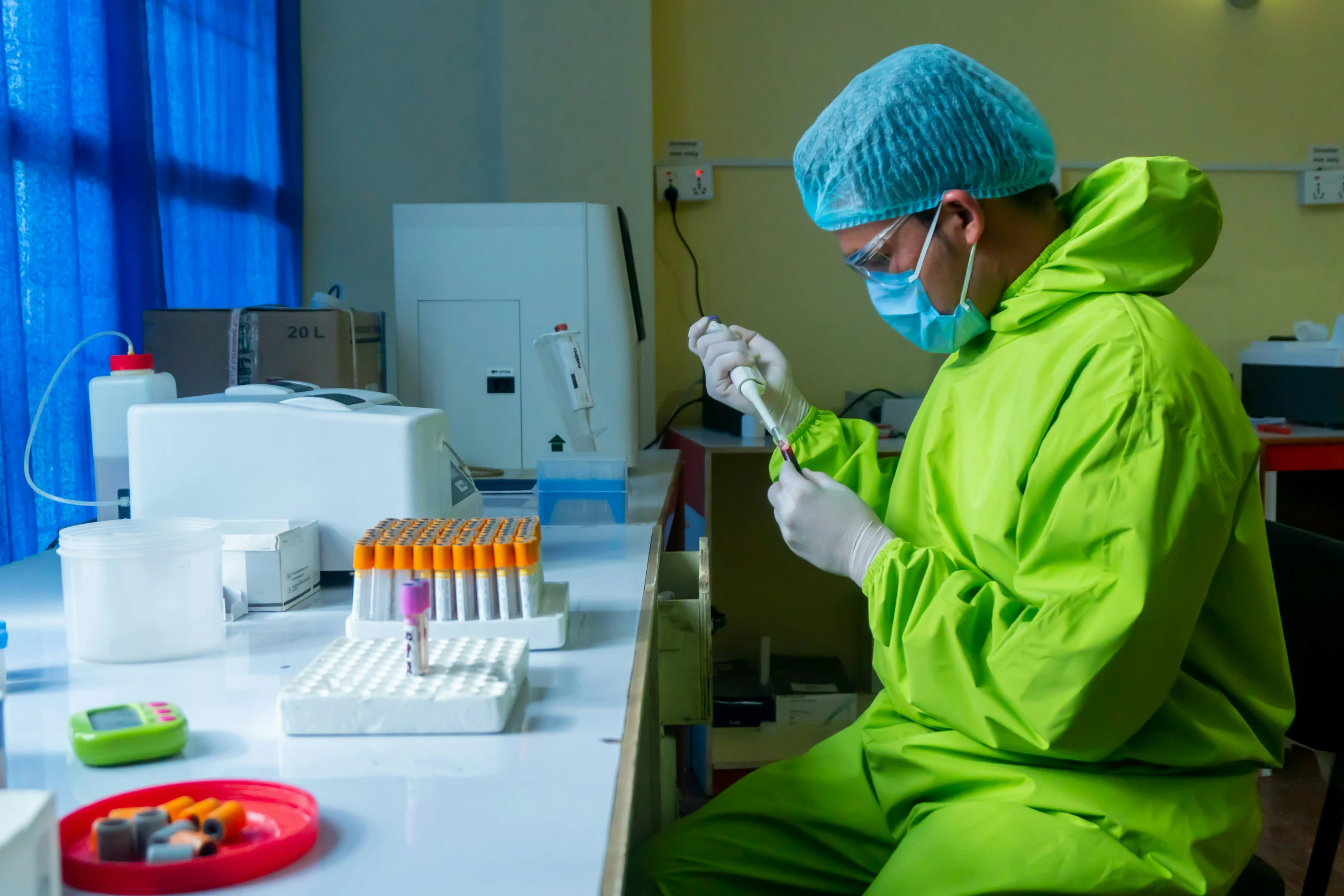 a person in green attire making a pipette