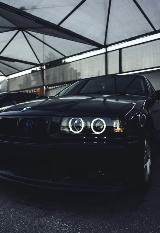 a black car sits in the parking lot