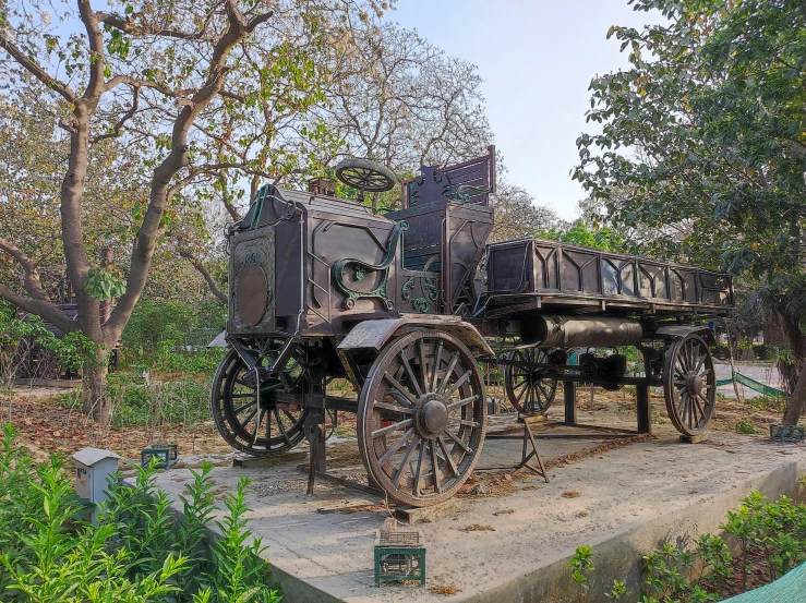 an old wagon that has been placed in the grass